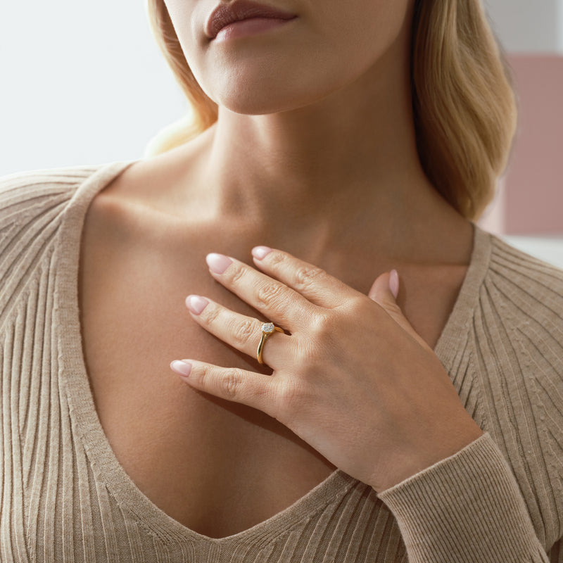 Boodles Brilliance yellow gold diamond engagement ring worn by a woman.