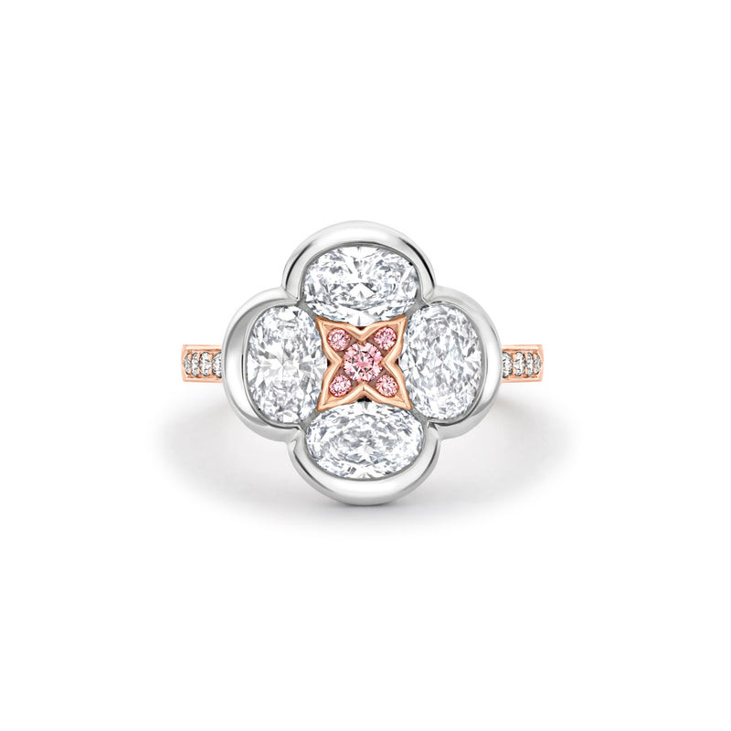 Boodles Posie ring featuring four oval white diamonds and a central rose gold motif set with pink diamonds.