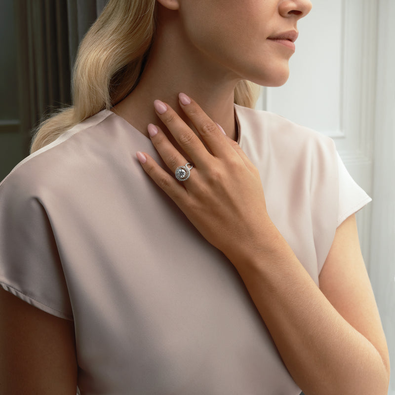 A Family Journey Monaco pink and white diamond ring in platinum and 18 carat rose gold worn by a woman.