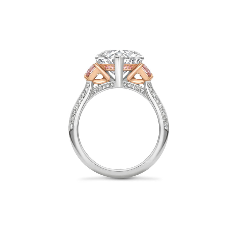 Side profile of the Petal platinum and rose gold ring, featuring a heart cut diamond and pink diamonds.