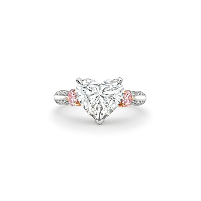 Boodles Petal platinum ring featuring a central heart-cut diamond and pink diamond side stones.