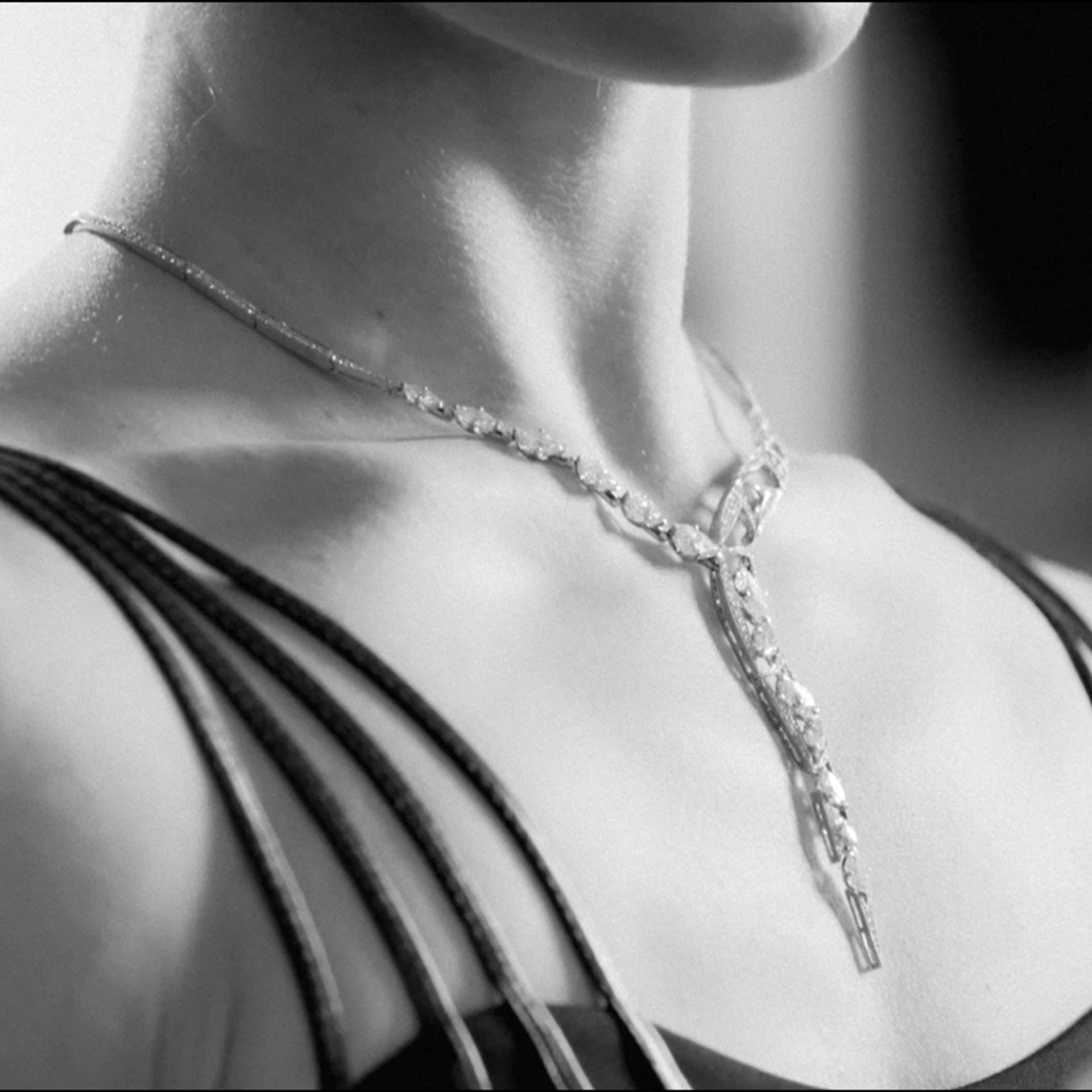 Pas De Deux Marquise Diamond Platinum Necklace by Boodles worn by a model in a black and white photograph.