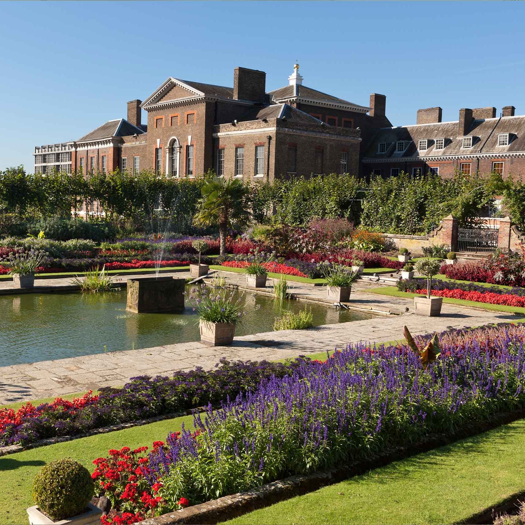 large historic building with a formal garden and pond. Historic Royal Palaces, Chelsea flower show, Boodles garden.
