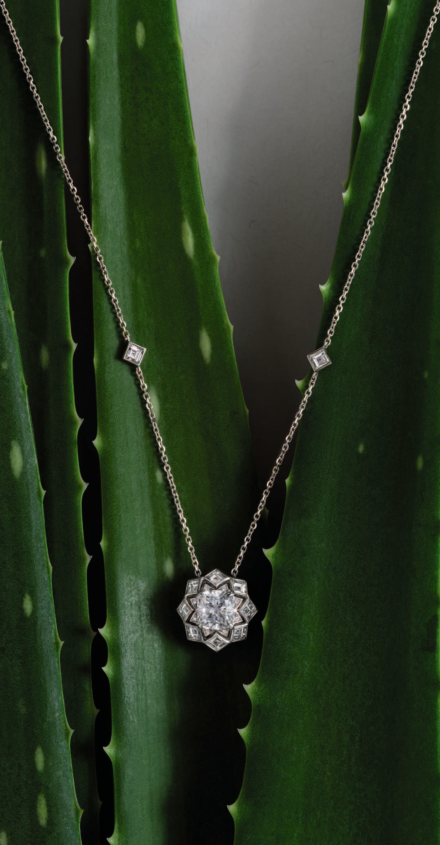 A spectacular 2.12 carat cushion shaped diamond, surrounded by carré cut diamonds and delicate enamel detail.