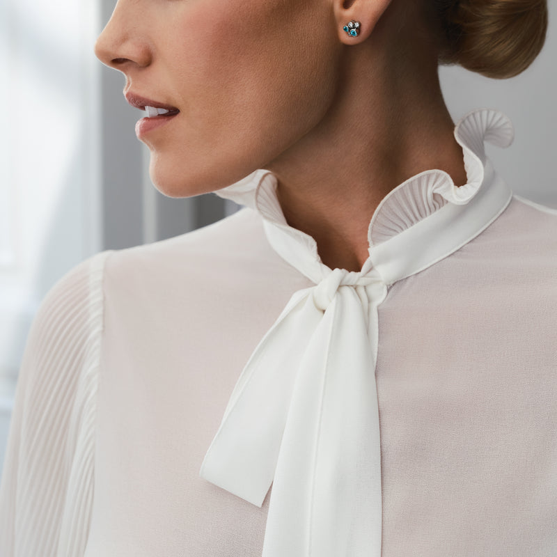 Raindance Paraiba tourmaline and diamond platinum cluster earrings worn by a woman.