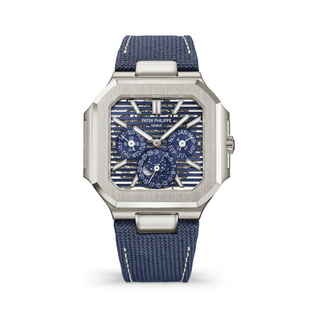 Patek Philippe Cubitus platinum watch with an openworked blue dial, perpetual calendar, and navy strap.