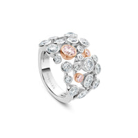 Boodles Raindance 25 platinum ring featuring scattered brilliant-cut white diamonds and three pink diamonds in rose gold.